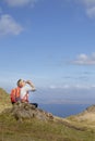 Woman trekking up to old man of storr on skye Royalty Free Stock Photo