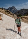 Woman Treks Across Snow Bank to Paintbrush Divide