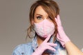 Woman in trendy fashion outfit during quarantine of coronavirus outbreak. Model dressed protective stylish handmade face mask