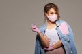 Woman in trendy fashion outfit during quarantine of coronavirus outbreak. Model dressed protective stylish handmade face mask