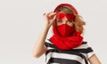 Woman in trendy fashion outfit during quarantine of coronavirus outbreak. Model in protective stylish red face mask Royalty Free Stock Photo