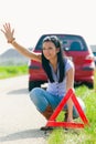 Woman with a triangle which has broken down