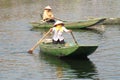 Woman in triangular hat in a paddle boat in Vietnam