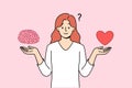 Woman tries to balance between getting education and romantic relationship, holding heart and brain Royalty Free Stock Photo