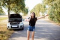 Woman tries to stop passerby car and ask for a help