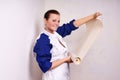 Woman tries on wall-papers to wall Royalty Free Stock Photo
