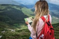 Woman tripper with a red backpack, voyager, holidaymaker lost in the mountain expeditions, school campaign trip Royalty Free Stock Photo