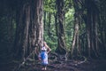 Woman on the tropical balinese landscape background, North of Bali island, Indonesia. Standing near Ficus tree. Royalty Free Stock Photo