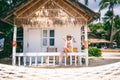 Woman tropical bungalow vacation on green background. Summer vacation. Beautiful sand beach.