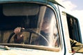 woman truck driver in the car. Girl smiling at camera and holding the steering wheel. Royalty Free Stock Photo