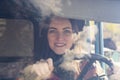 Woman truck driver in the car. Girl smiling at camera and holding the steering wheel. Royalty Free Stock Photo