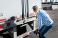 Woman truck driver checking her trailer seal number Royalty Free Stock Photo