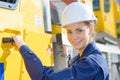 Woman truck driver getting in cabin Royalty Free Stock Photo