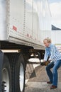 Woman Truck Driver Raising Trailer legs Royalty Free Stock Photo