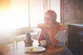 Woman on true kitchen sitting on a table with bread