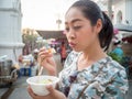 Woman try streetfood.