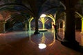 Woman try to reach the well in the heart of Portuguese Cistern - famous tourist attraction of El Jadida