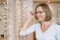 Woman trying on eyeglasses at optometrists