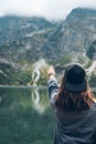 woman trying reach out the sky landscape view of lake at mountains