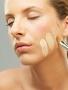 Woman trying shades of foundation on jaw Royalty Free Stock Photo