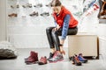 Woman trying shoes for hiking in the shop