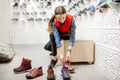 Woman trying shoes for hiking in the shop