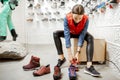Woman trying shoes for hiking in the shop