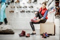 Woman trying shoes for hiking in the shop