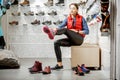 Woman trying shoes for hiking in the shop