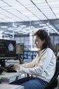 Woman trying to fix error in high tech AI data center workplace, solving tasks