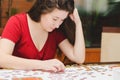 Woman trying to match pieces of a Jigsaw Puzzle Game. Royalty Free Stock Photo