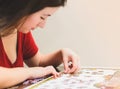 Woman trying to match pieces of a Jigsaw Puzzle Game. Royalty Free Stock Photo