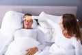 Woman Trying To Stop Man`s Snoring With Her Finger Royalty Free Stock Photo