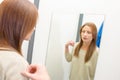 Woman trying top in fitting room