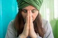 Woman in turban with eyes closed holding hands in Namaste sign Royalty Free Stock Photo