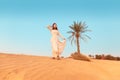 Woman in turban travels in Sahara desert. Adventure and life experience concept Royalty Free Stock Photo