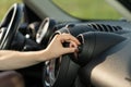 Woman turn on air conditioner in car at vehicle panel grid cooling system. Automobile conditioning Royalty Free Stock Photo