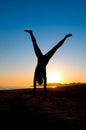 Woman Turning Cartwheel On Beach