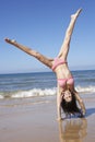 Woman Turning Cartwheel On Beach Holiday Royalty Free Stock Photo