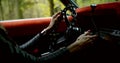 Woman is turning ignition key sitting in car and holding hands on steering wheel, closeup view Royalty Free Stock Photo