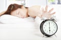 Woman turning off the alarm clock Royalty Free Stock Photo