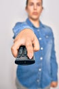 Woman turning off television holding tv remote control