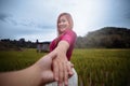 Woman turning and smiling while holding your hand hand.