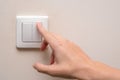 Woman turns on a light switch inside a room
