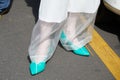 Woman with turquoise shoes and white trousers before Blumarine fashion show, Milan Fashion Week street style