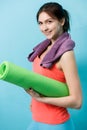 Woman with twisted fitness mat