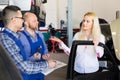 Woman and two auto mechanics