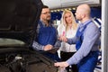 Woman and two auto mechanics