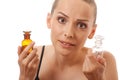 Woman with two bottles of medicine or perfume Royalty Free Stock Photo