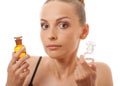 Woman with two bottles of medicine or perfume Royalty Free Stock Photo